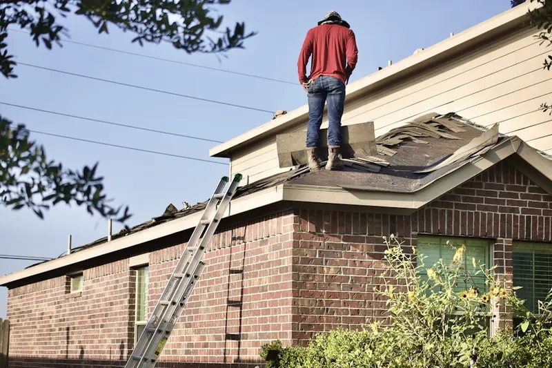 Professional roofer working on a residential roof in Downtown State College